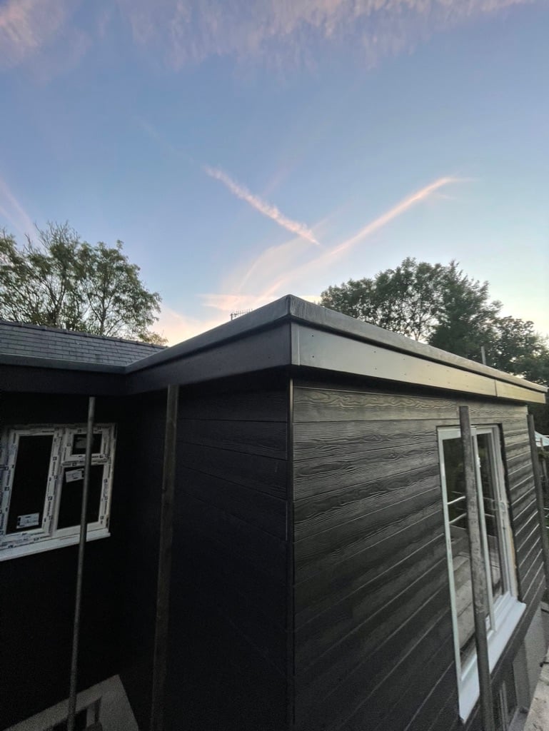 Black timber clad extension at dusk