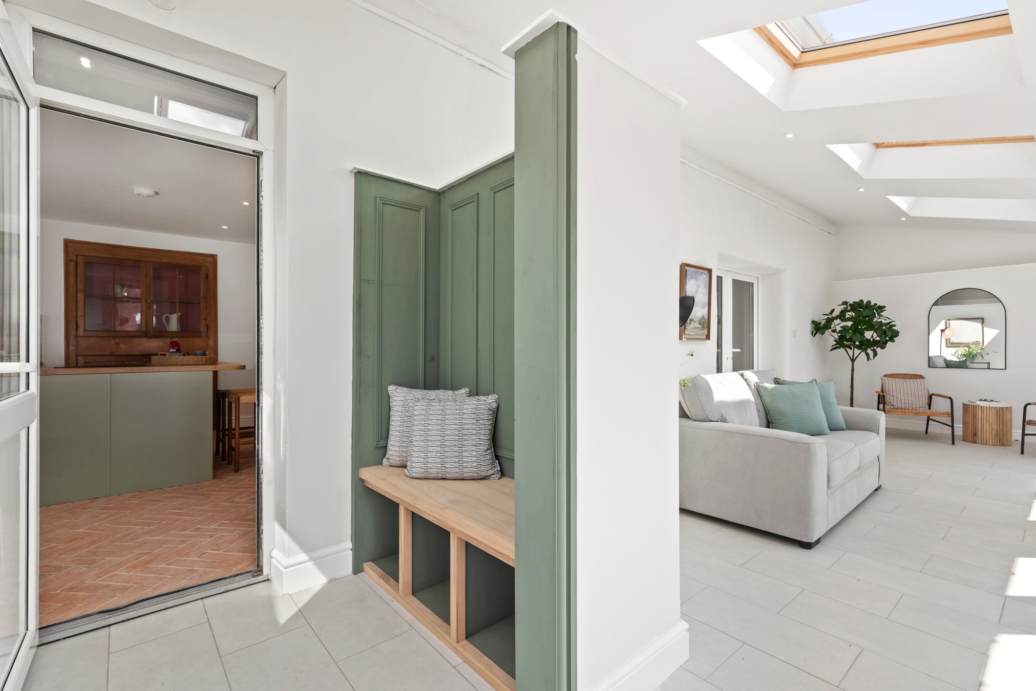 Hallway with green panelling and boot room