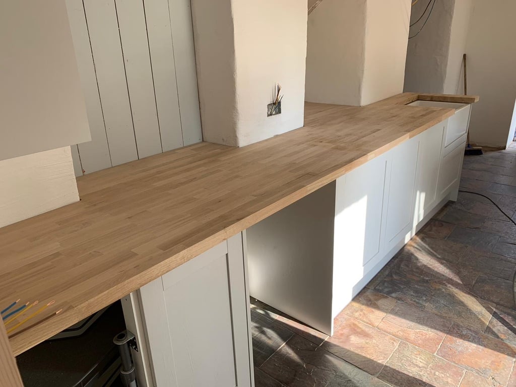 Kitchen with oak worktop and stone flag floor