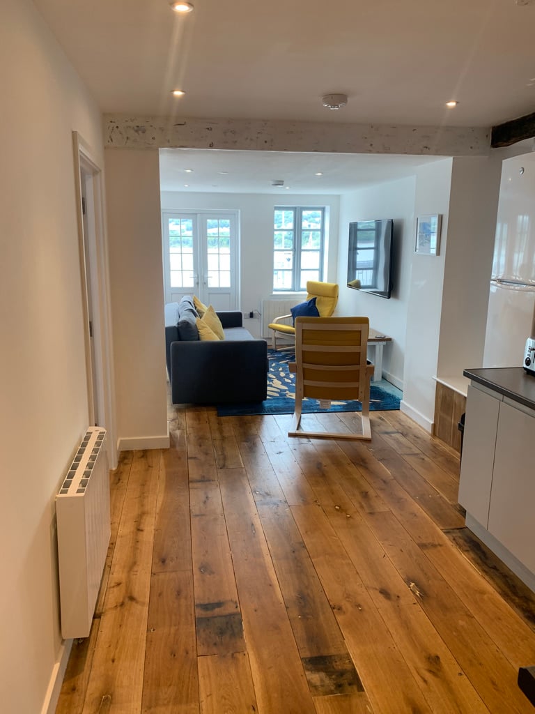 Open plan living room with oak flooring